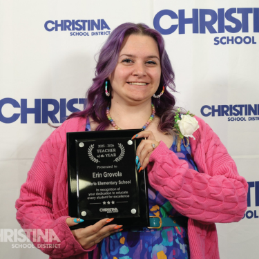 Photo of Erin Grovola Oberle ES Teacher of the Year holding plaque
